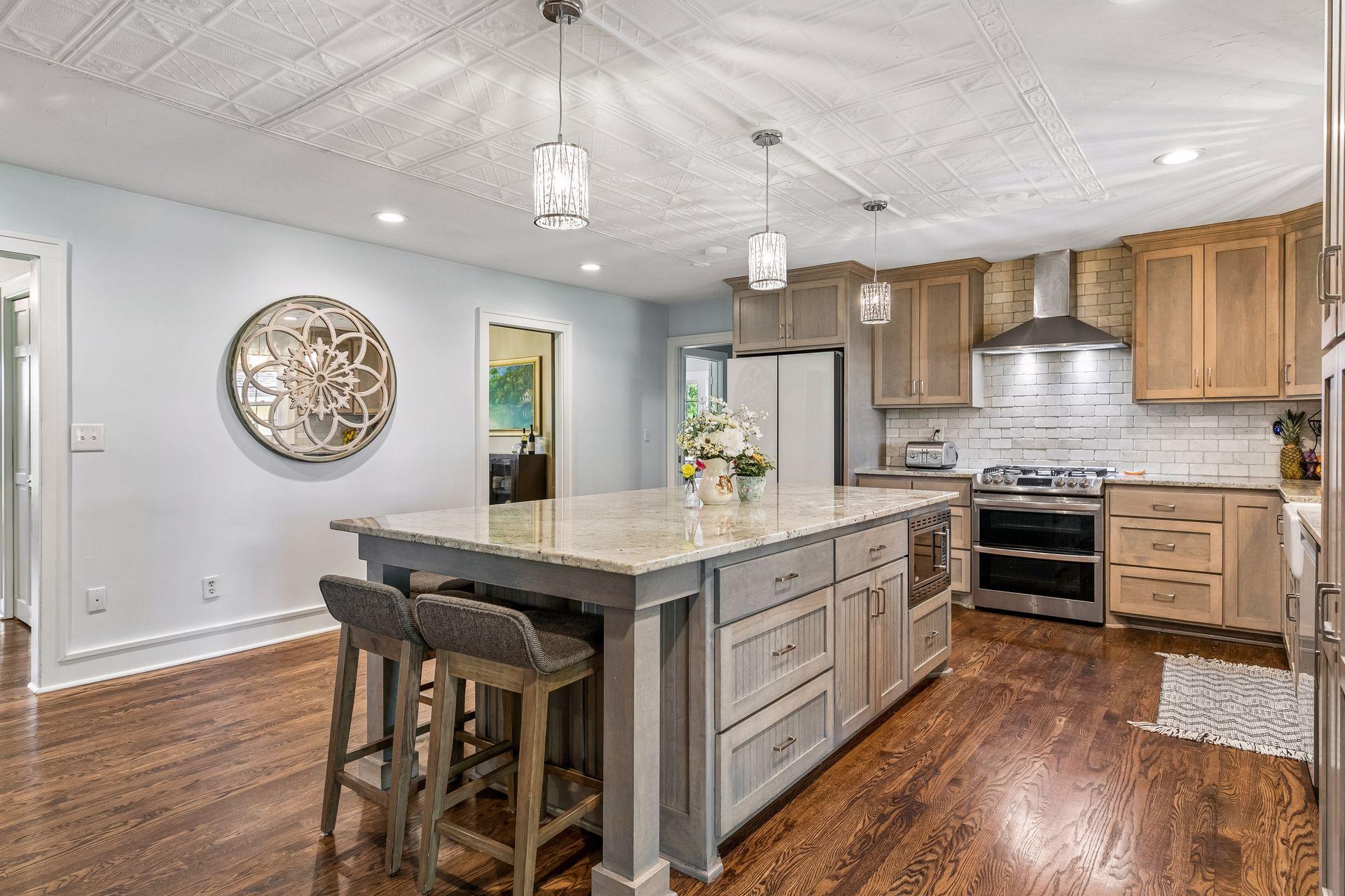 This chef's kitchen has a double oven gas range, a microwave tucked discreetly in the island and large walkways for many cooks.