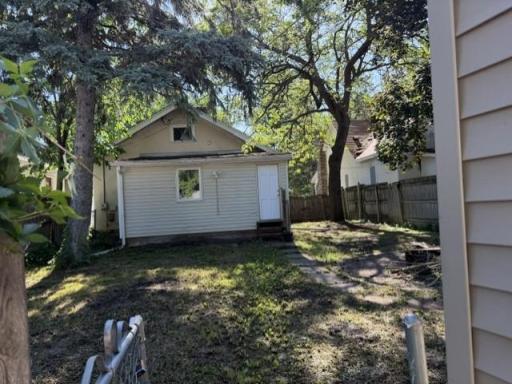 View of the backyard from the gate near the garage and entry from alley.