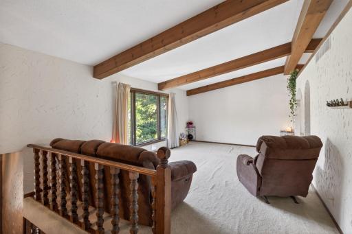 Upper level living area. Gorgeous exposed beams & archways