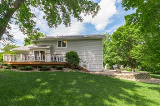 View of home with the side deck and backyard patio.