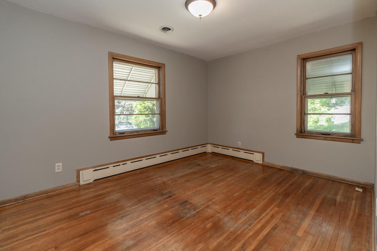 Main level 1st bedroom with hardwood floors.