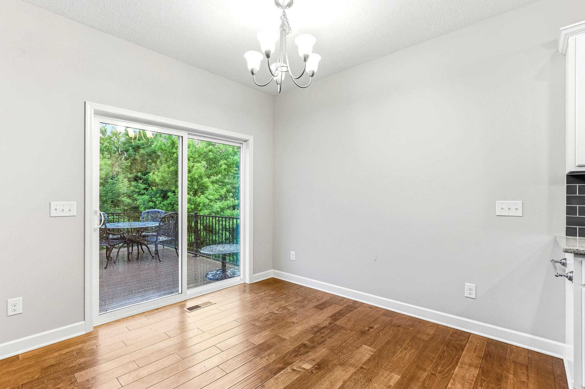 Bright dining space featuring a sliding glass door that opens directly onto a charming deck creating a seamless indoor-outdoor connection