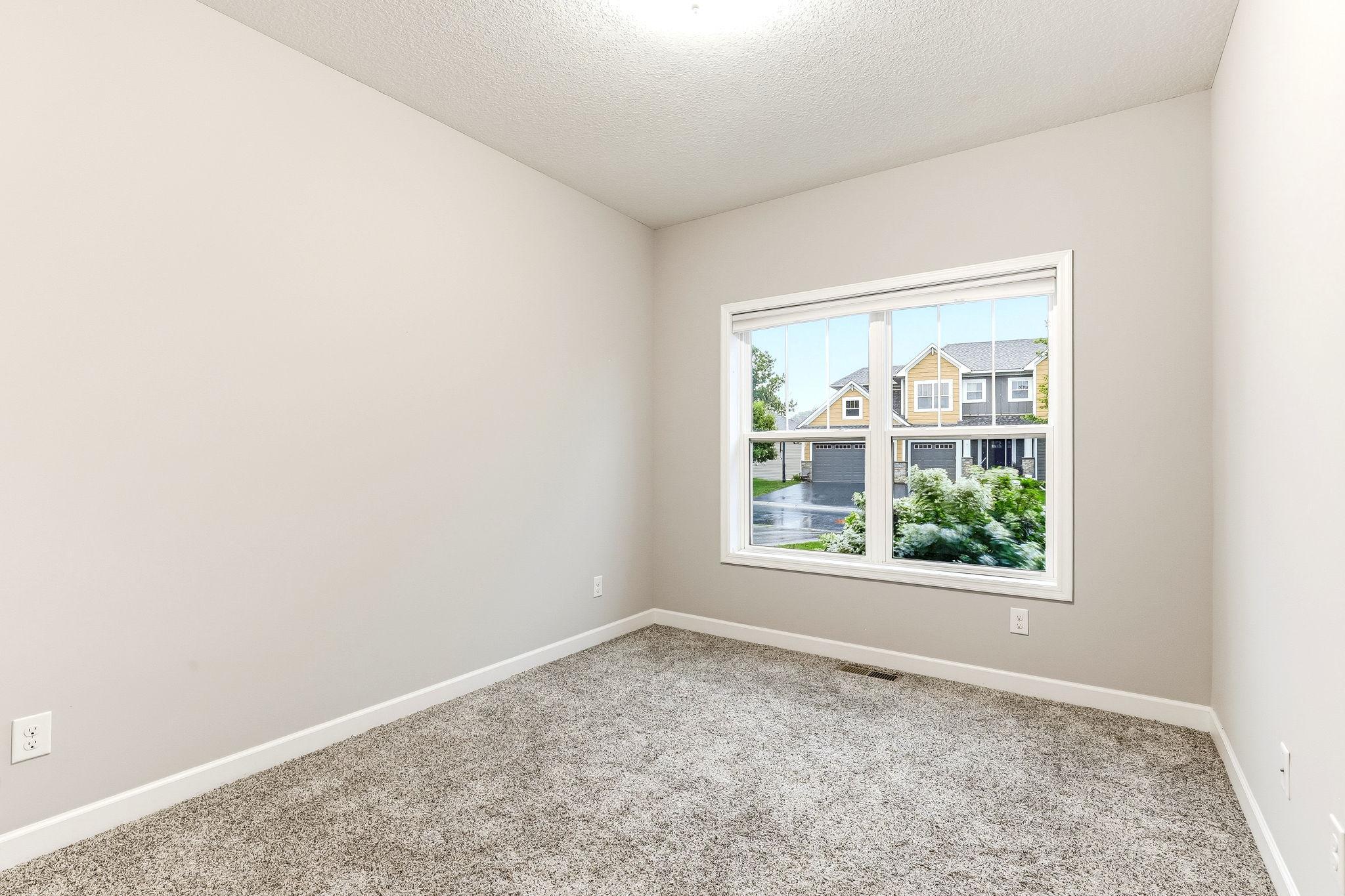 Bright and comfortable second main-level bedroom offering flexible use for guests, family, or a home office.