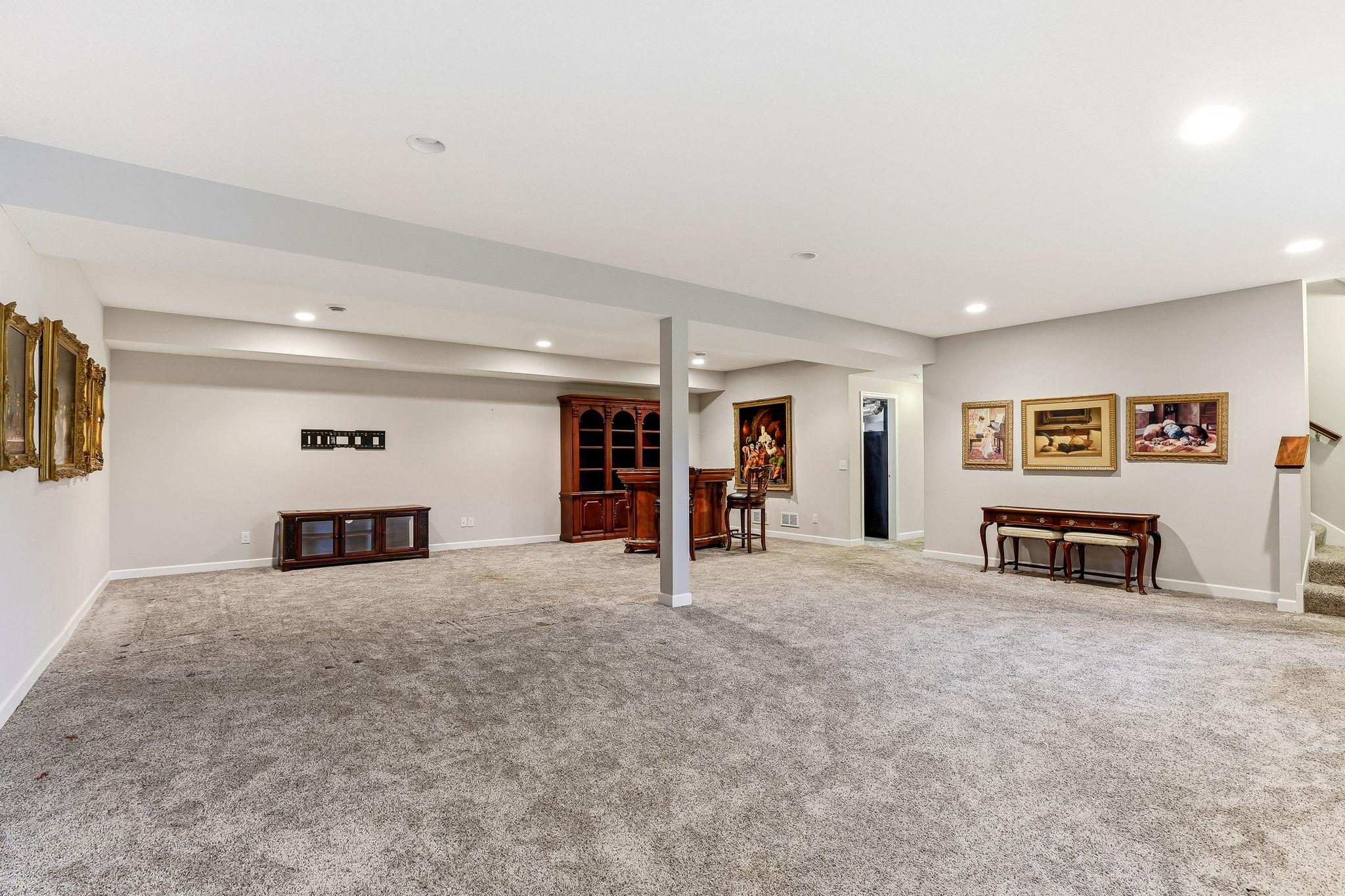 A spacious, comfortable family room with bright lighting and an open layout—perfect for movie nights, games, or relaxed everyday living.