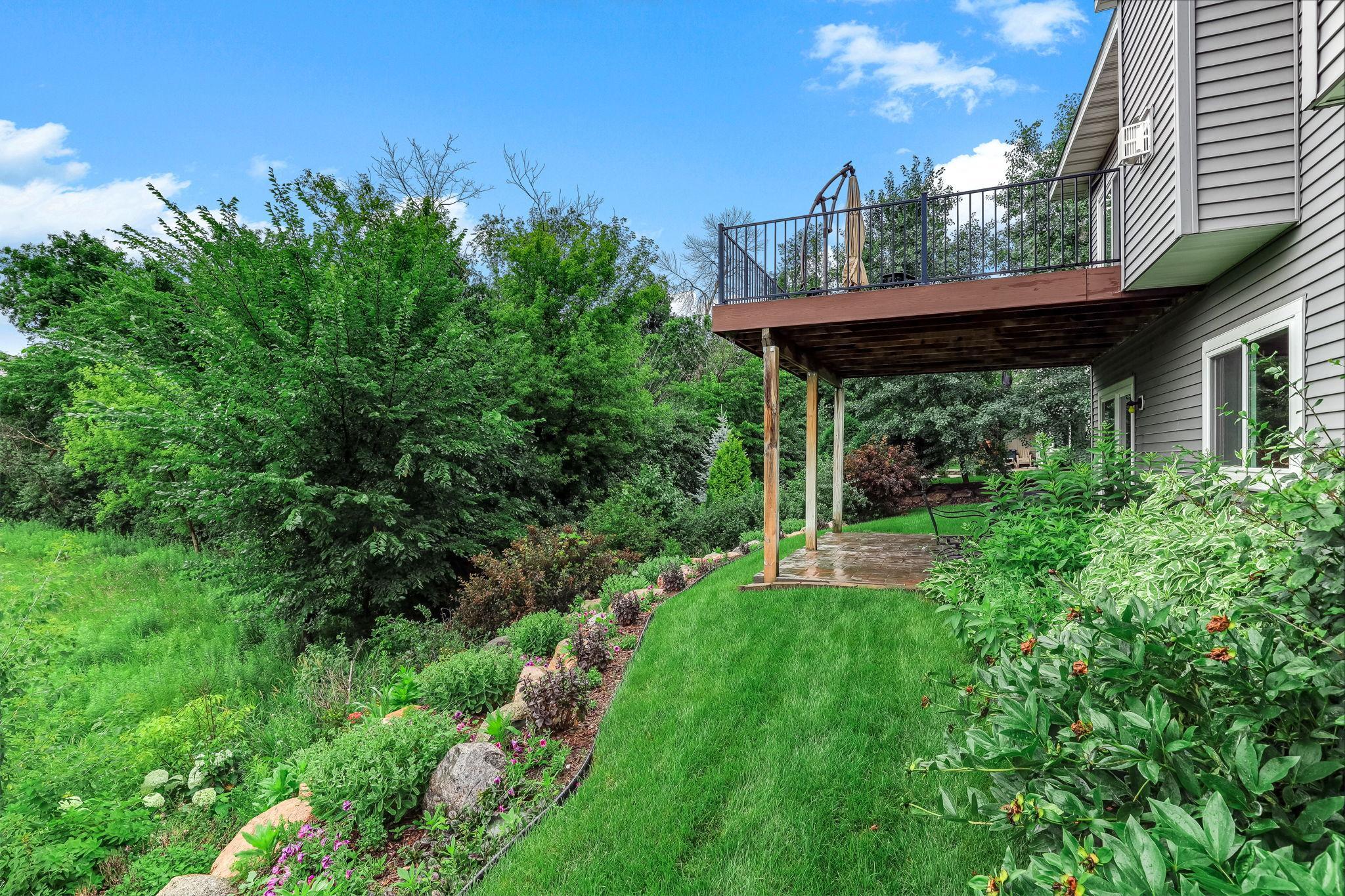 A thoughtfully sculpted landscaped creates a natural, tiered transition in the yard.