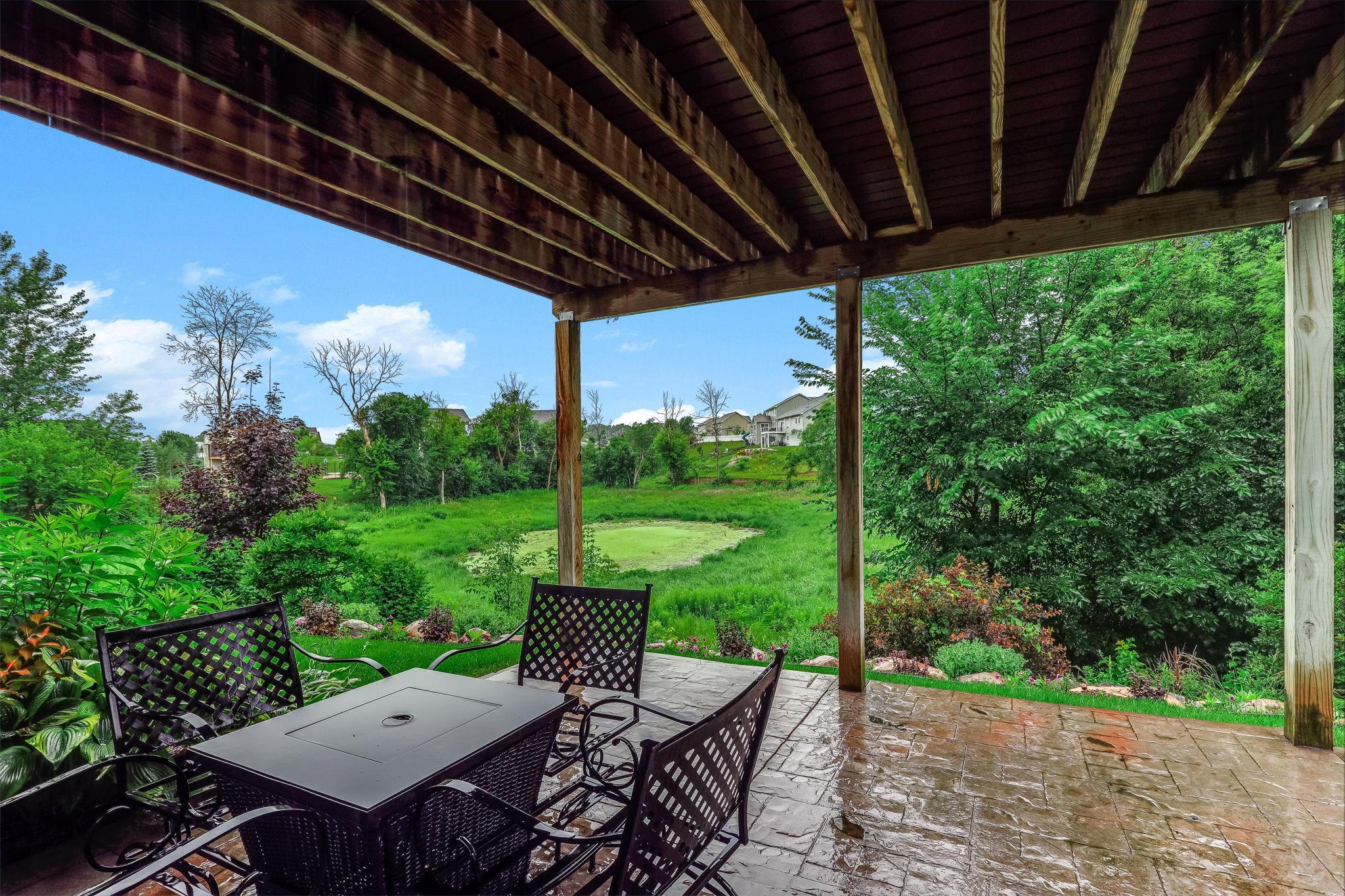 A peaceful lower-level patio with a serene view of the pond, offering a quiet outdoor retreat perfect for relaxing, entertaining, or enjoying nature right from home.