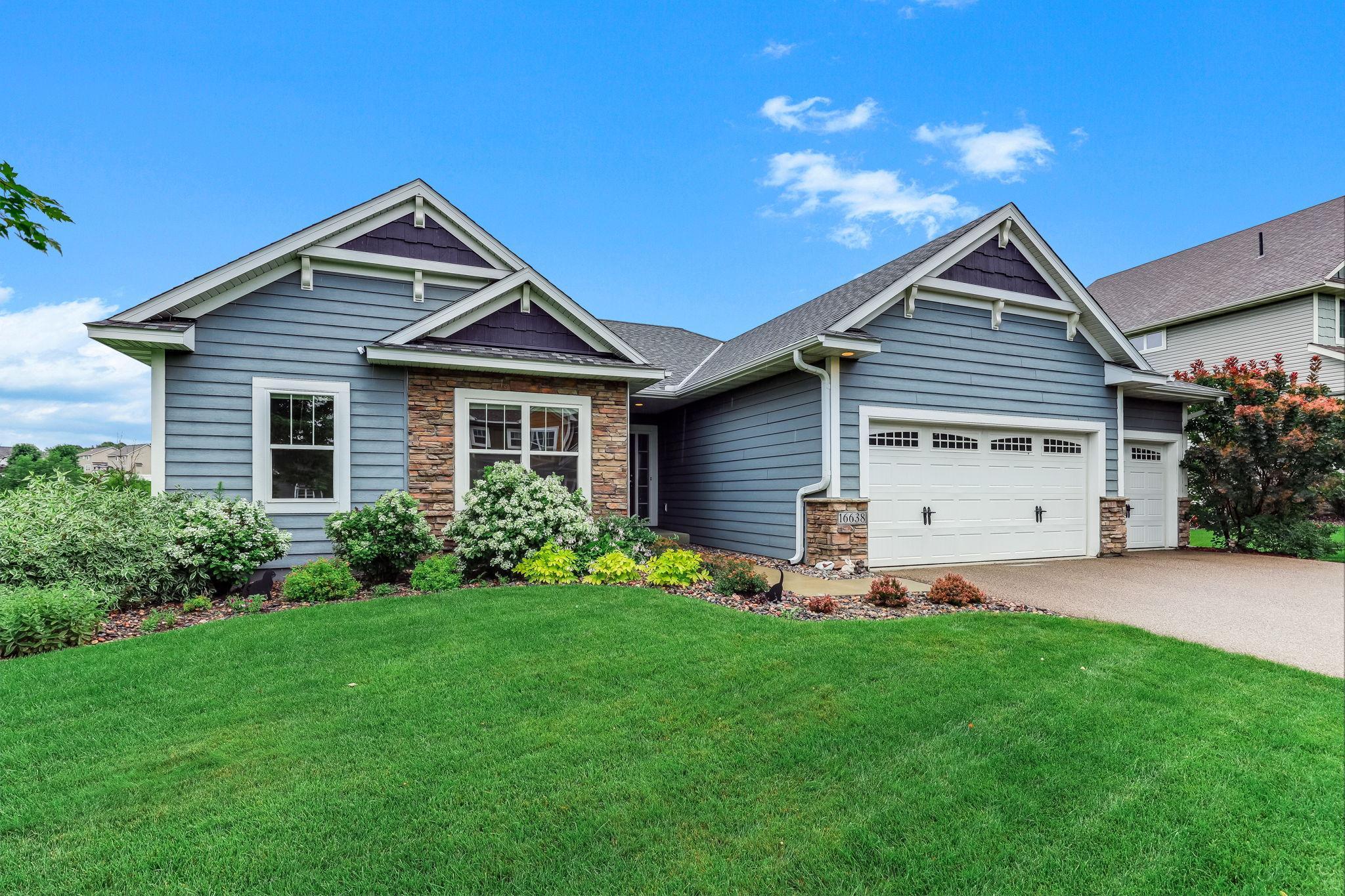 Thoughtfully designed landscaping frames the home with polished curb appeal and a welcoming, well-kept presence.