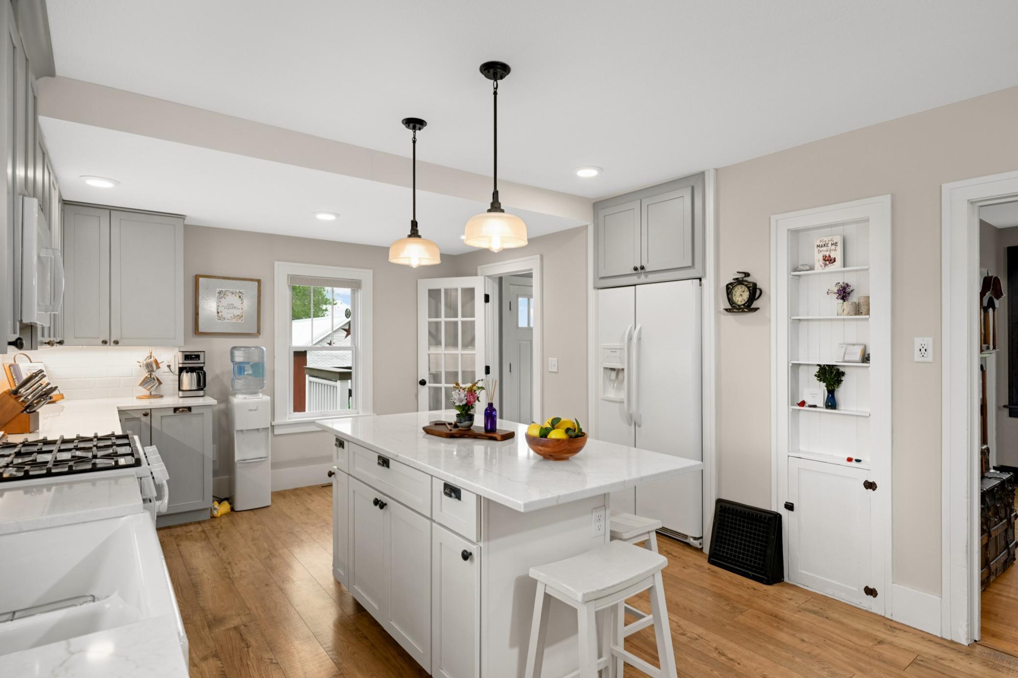 So much space and character in this kitchen with niche built-in and center island offering snack bar seating