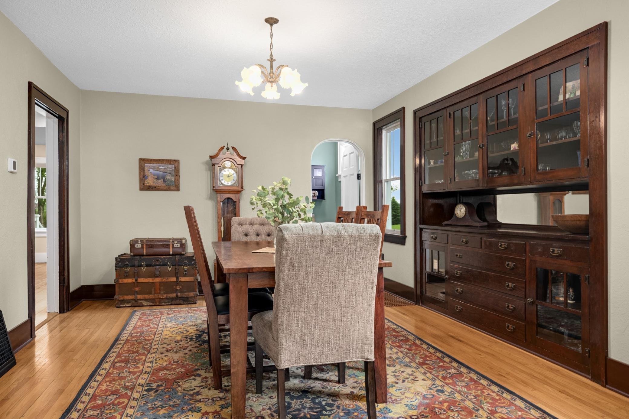 Charming built-in buffet creates a true sense of character in this spacious dinning room and arched doorway to full bath