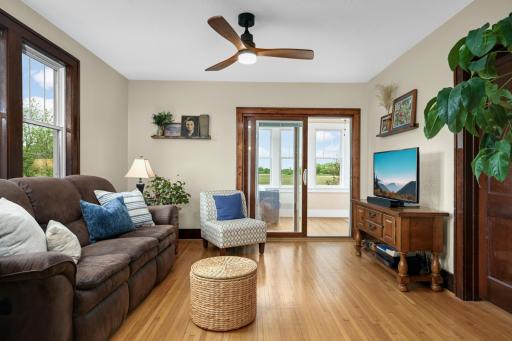Original hardwood floors in this living room with access to front porch