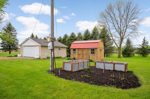 Garden with raised garden beds and storage shed with 2 car garage.