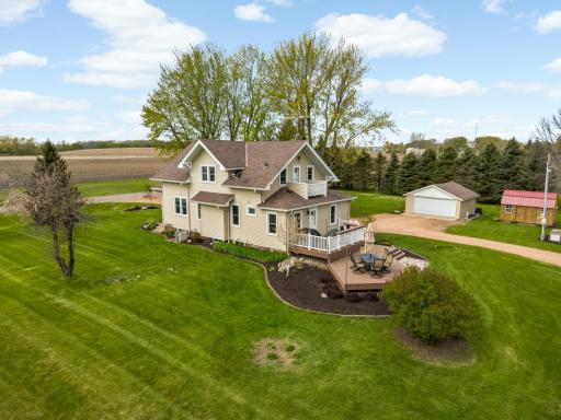 Perfectly manicured landscaping surrounds this farmhouse.