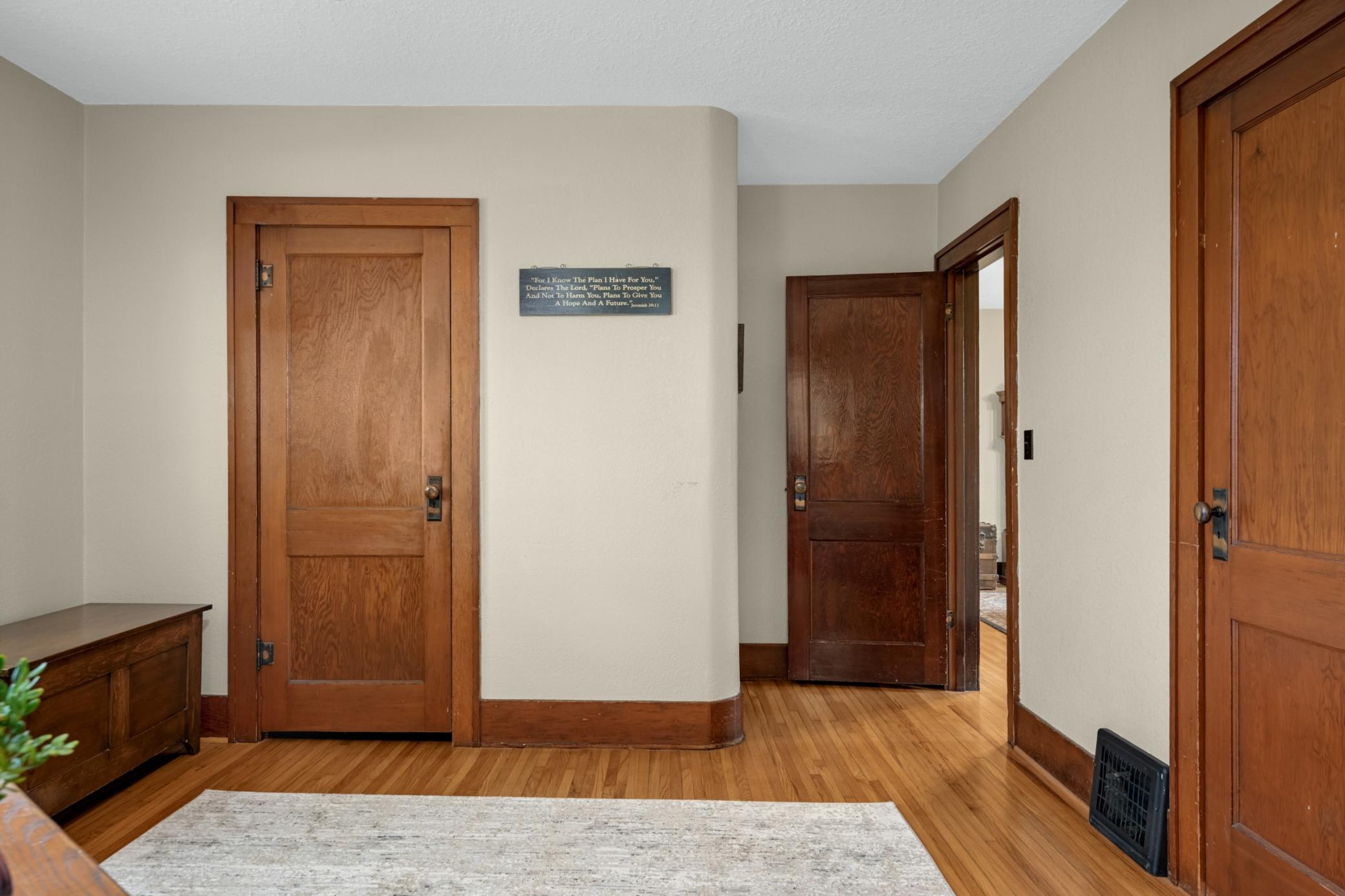 Stunning 2 panel wood doors and large trim with original hardwood floors.