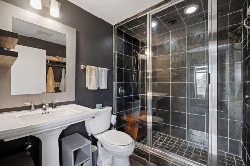 Primary bath features walk in shower with dual shower heads.