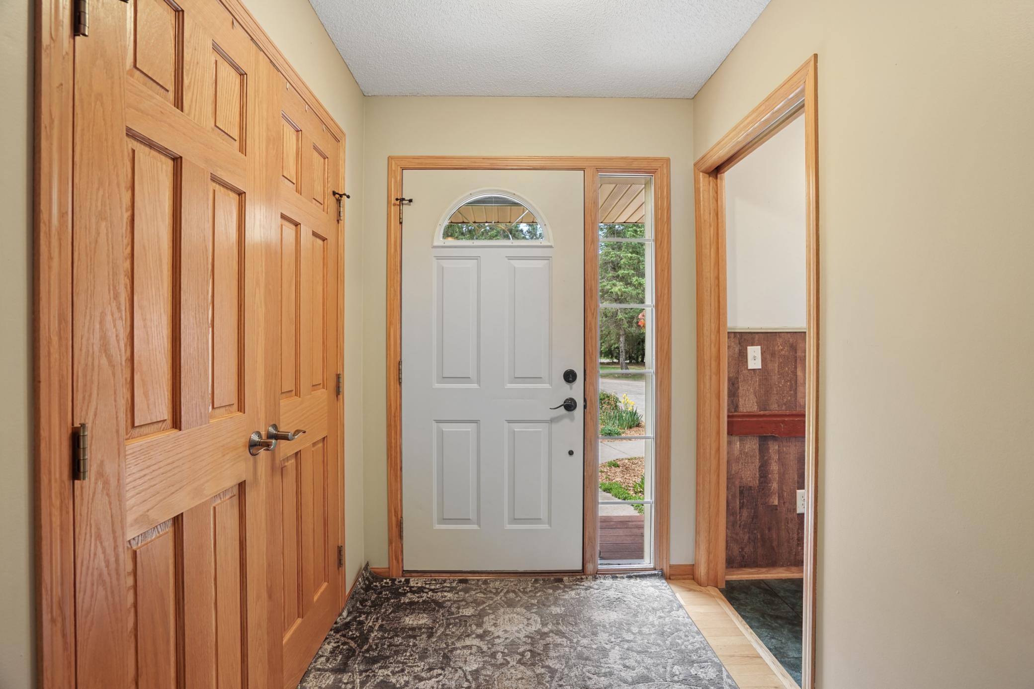 Large foyer welcomes you in with solid panel doors, large closet, hardwood floors, and the convenience of main floor laundry right off the garage.