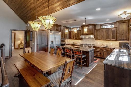Gather around! Spacious kitchen with a cozy dining table, island seating, and plenty of room to cook and connect. (not pictured are two dishwashers)