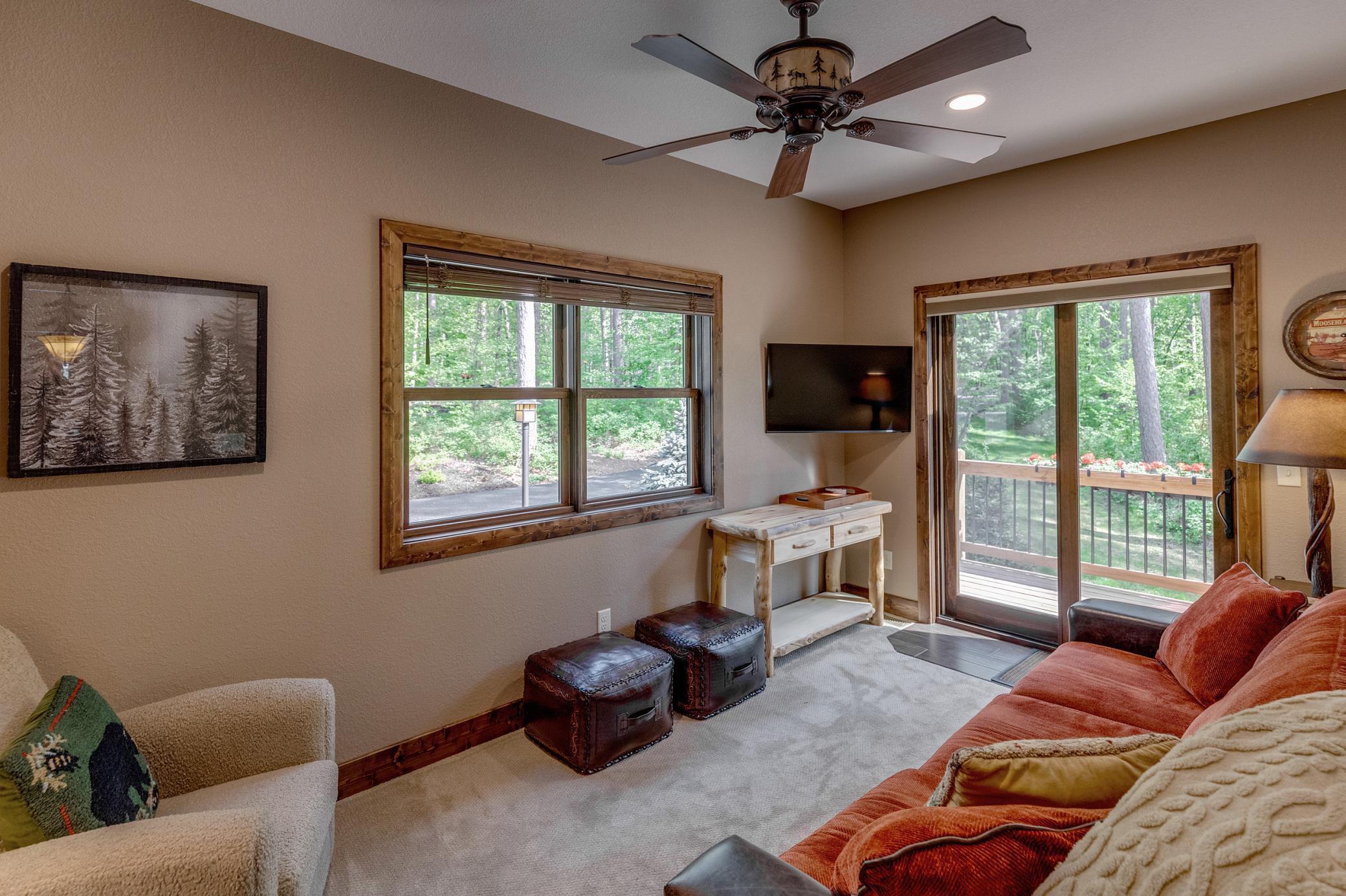 Bright and inviting space off of the primary bedroom. Perfect for relaxing or catching your favorite show, with easy access to the outdoors.