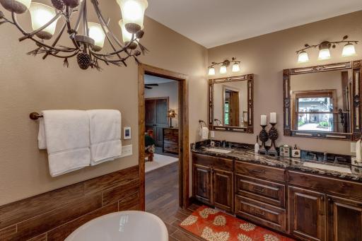 Spa-like primary bathroom featuring dual sinks, elegant mirrors, and easy access to your serene bedroom retreat.