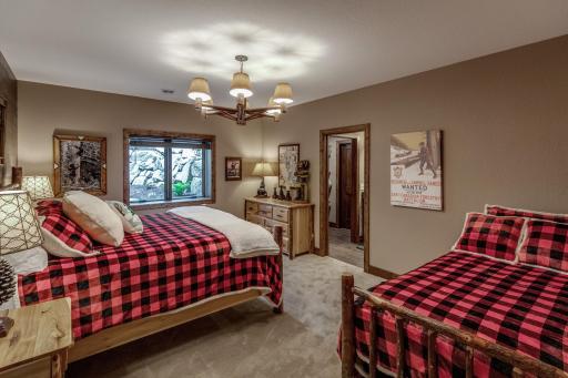 Comfortable downstairs bedroom with two beds and plenty of natural light—a perfect spot for family or guests.