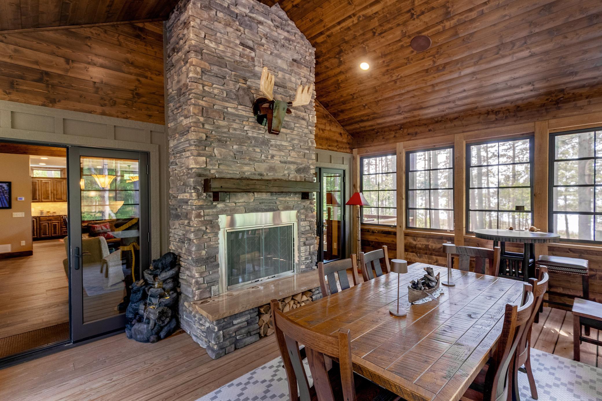 Indoor-outdoor living perfected: vaulted wood ceilings and a warm fireplace make this porch your favorite hangout.