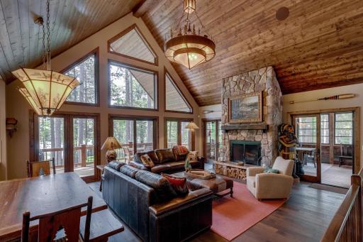 Elegant and warm: wood ceilings and a stone fireplace make this living room a true showstopper.