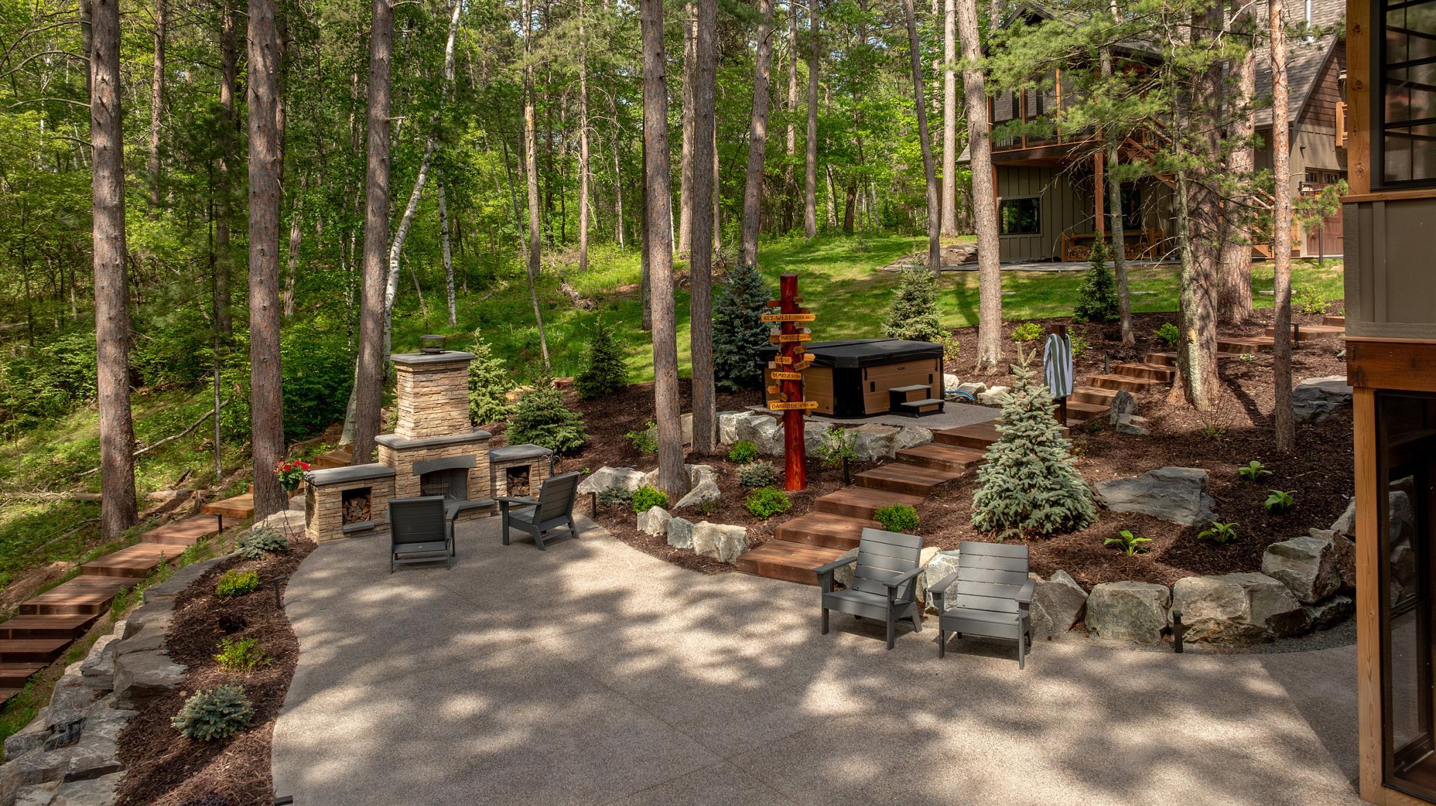 From BBQs to hot tub evenings, this backyard oasis surrounded by trees has it all.