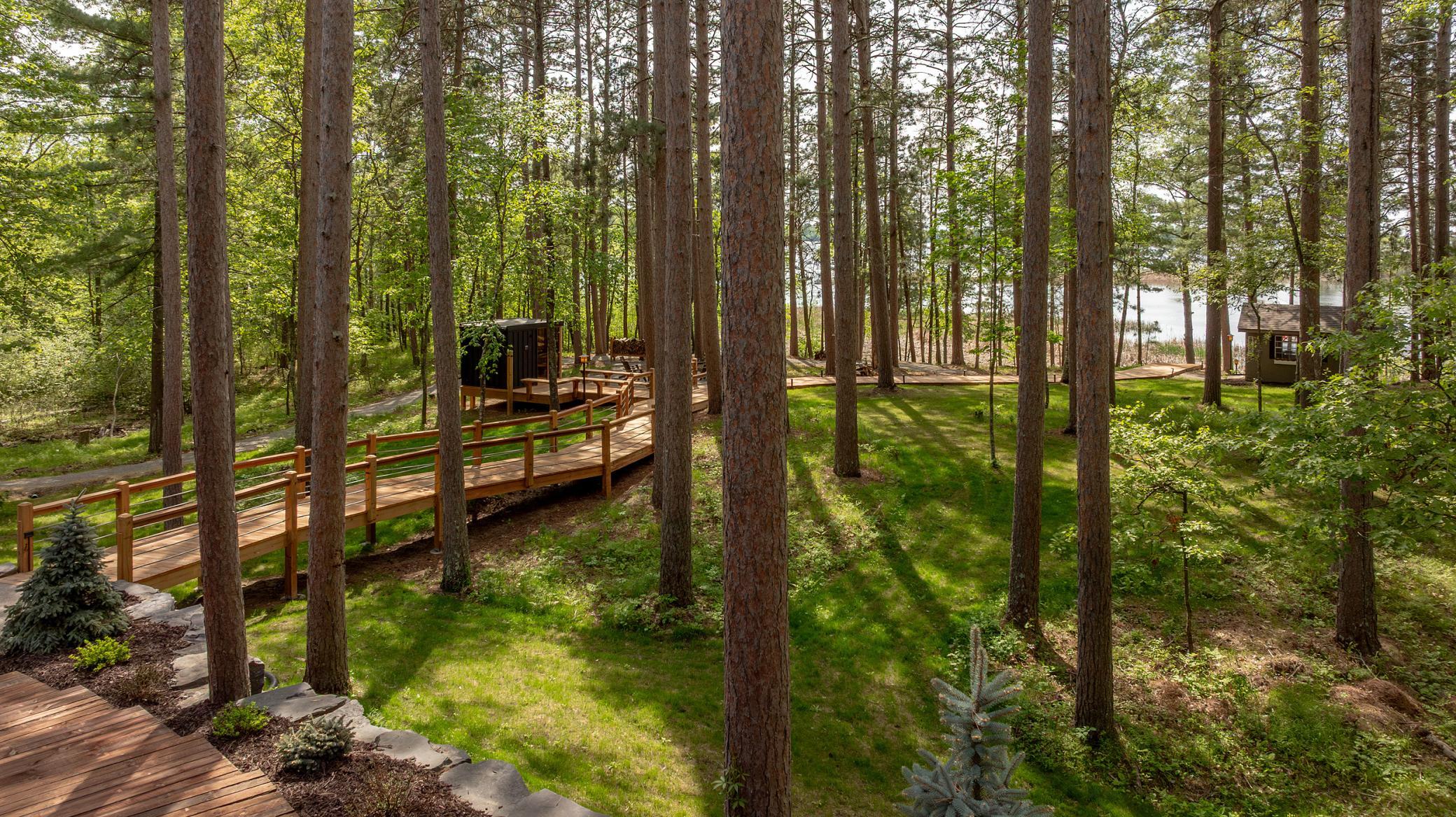 Take a stroll through nature on your own boardwalk path, with serene lake views peeking through the trees.