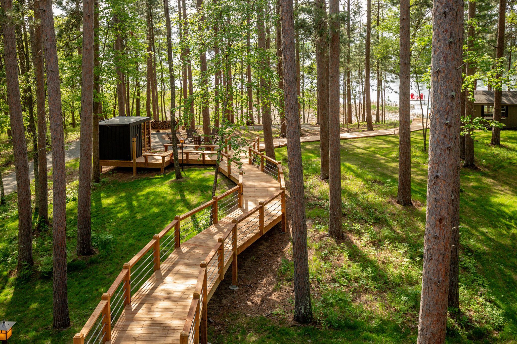 A charming bridge and picturesque walkway that creates a beauifl approach to the shoreline