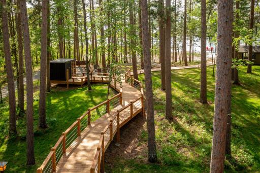 A charming bridge and picturesque walkway that creates a beauifl approach to the shoreline