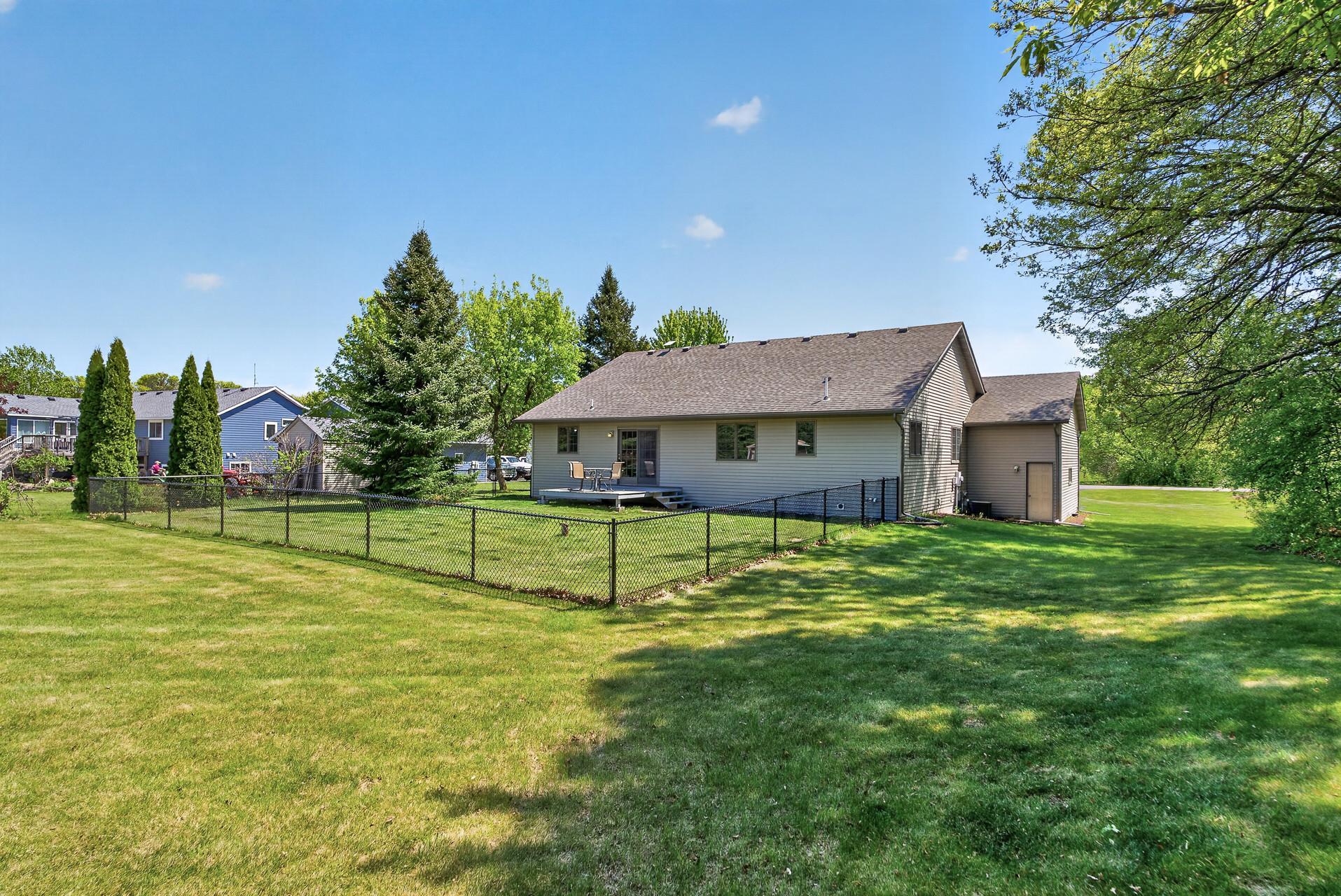 A fenced in portion of the spacious backyard.