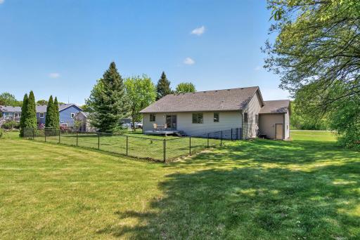 A fenced in portion of the spacious backyard.