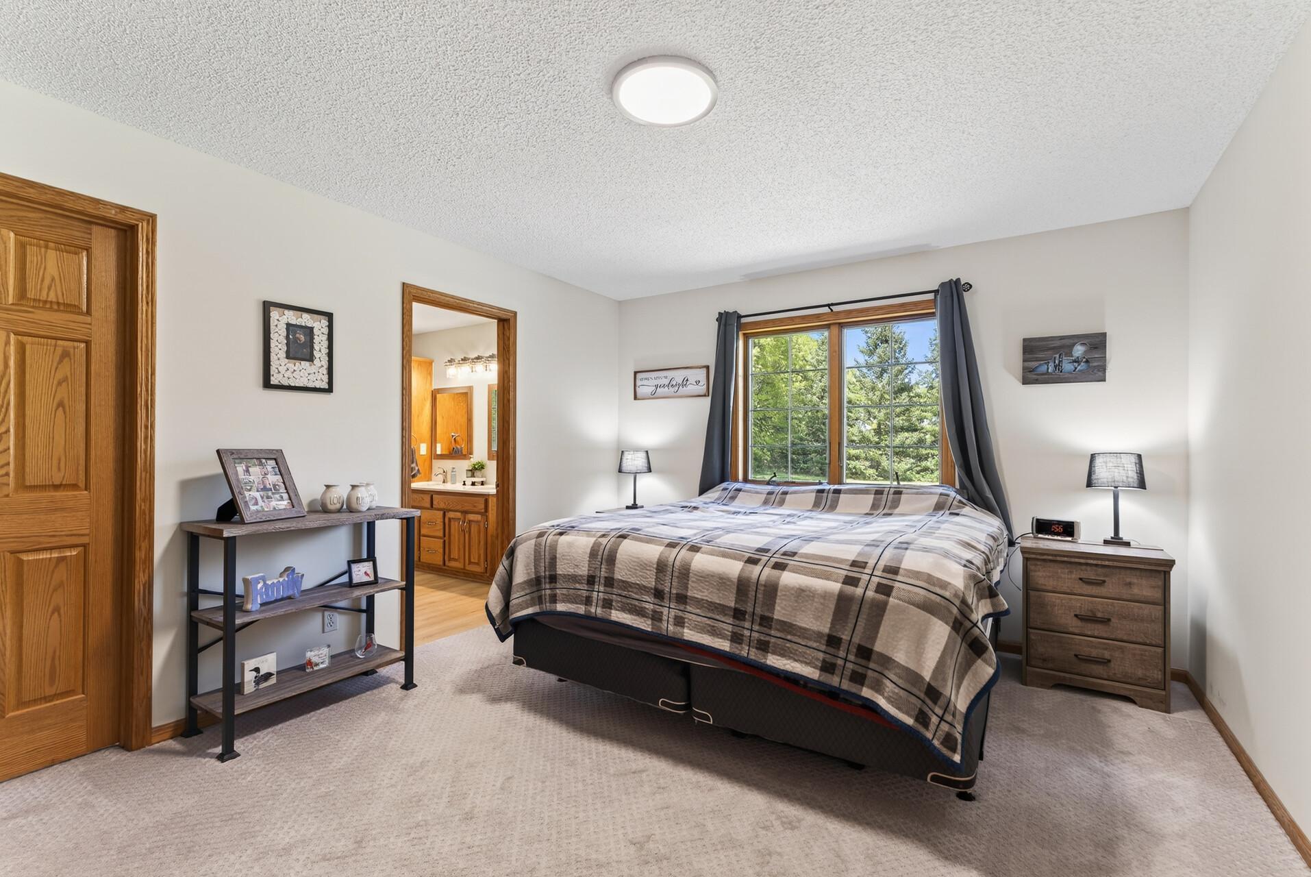 Primary bedroom with a walk-in closet and full bath.