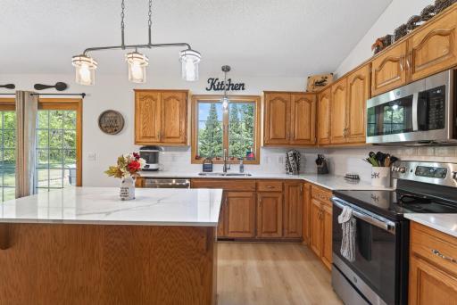 Solid-surface countertops and stainless appliances.