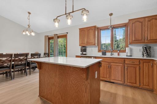 Solid-surface countertops and stainless appliances.