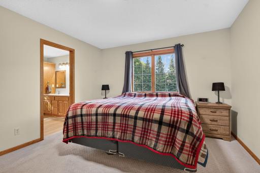 Primary bedroom with a walk-in closet and full bath.