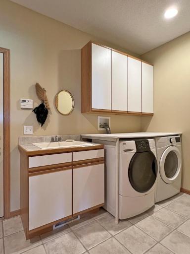 Spacious main floor laundry room w/prep area and plentiful storage