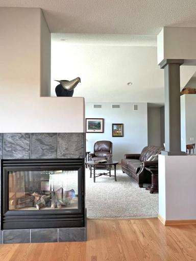 Architectural details and gas fireplace between great room and kitchen