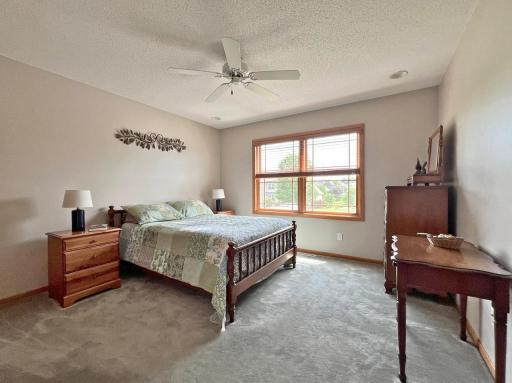 Large upstairs bedroom with views of professionally landscaped yard