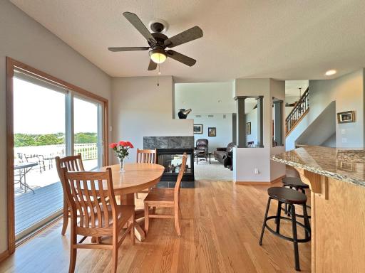 Bright breakfast area with hardwood floors, large windows, and an open connection to the kitchen and great room
