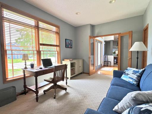 View of professionally landscaped yard through window of main floor office