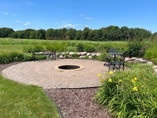 Enjoy lazy summer afternoons and spectacular views on background patio firepit area