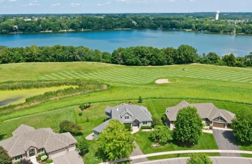 Elevated view highlighting the home's premier setting near Lake Bavaria and the rolling fairways of Chaska Town Course
