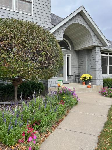 Front view in early autumn as you approach the covered entry