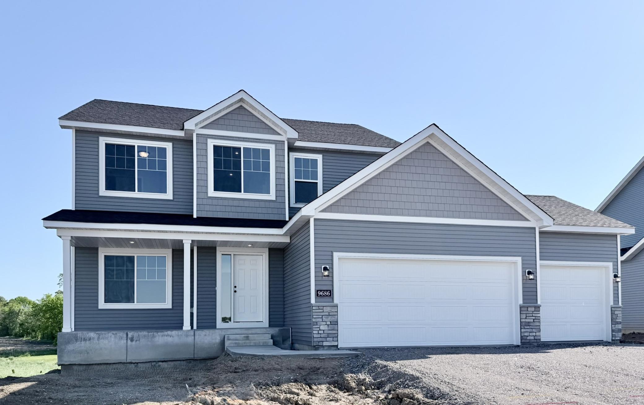 9686 32nd St NE- Home is ready for a Quick Move-in! Highlights include a spacious 4 BAY GARAGE located on a WALKOUT HOMESITE! Sod, Irrigation System, & Front Plantings included. Driveway will be installed and front door painted soon.