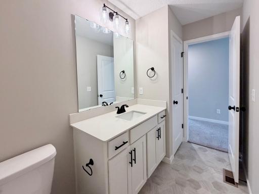 9686 32nd St NE- Upper Level Main Full Bath includes a Linen Closet for added storage.