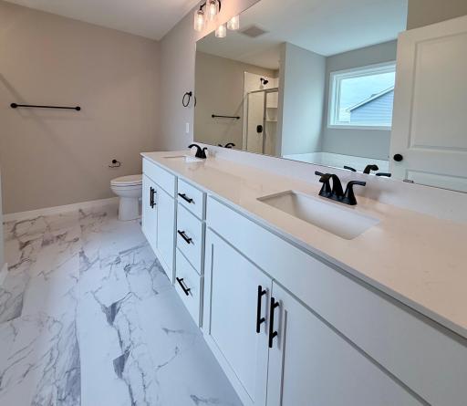 9686 32nd St NE- Primary Suite Deluxe Bath offers a Double Sink Vanity with Soft Close Doors & Drawers and LVT Flooring.