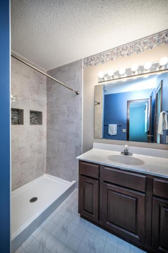 Private primary bath features a nice-sized tiled shower, vanity and newer toilet.