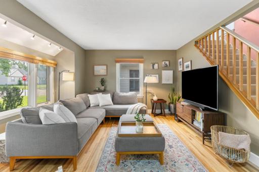 The nice living room features original hardwood floors and updated windows