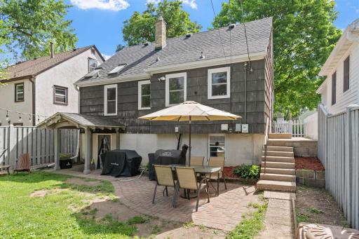 Fully fenced yard and paver patio. Notice the overhang for the basement level amd the side entry to the home as well