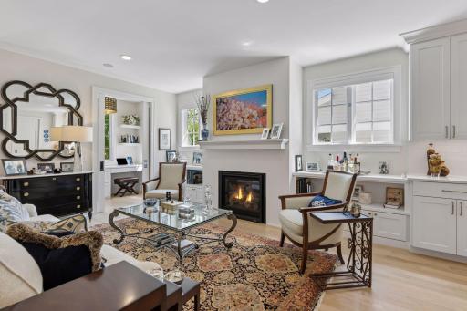 The Great Room has a beautiful gas fireplace flanked by bookshelves, cabinets and windows